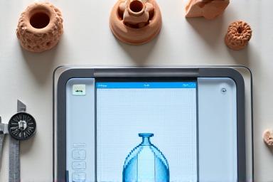 A potter reviewing 3D ceramic prototypes